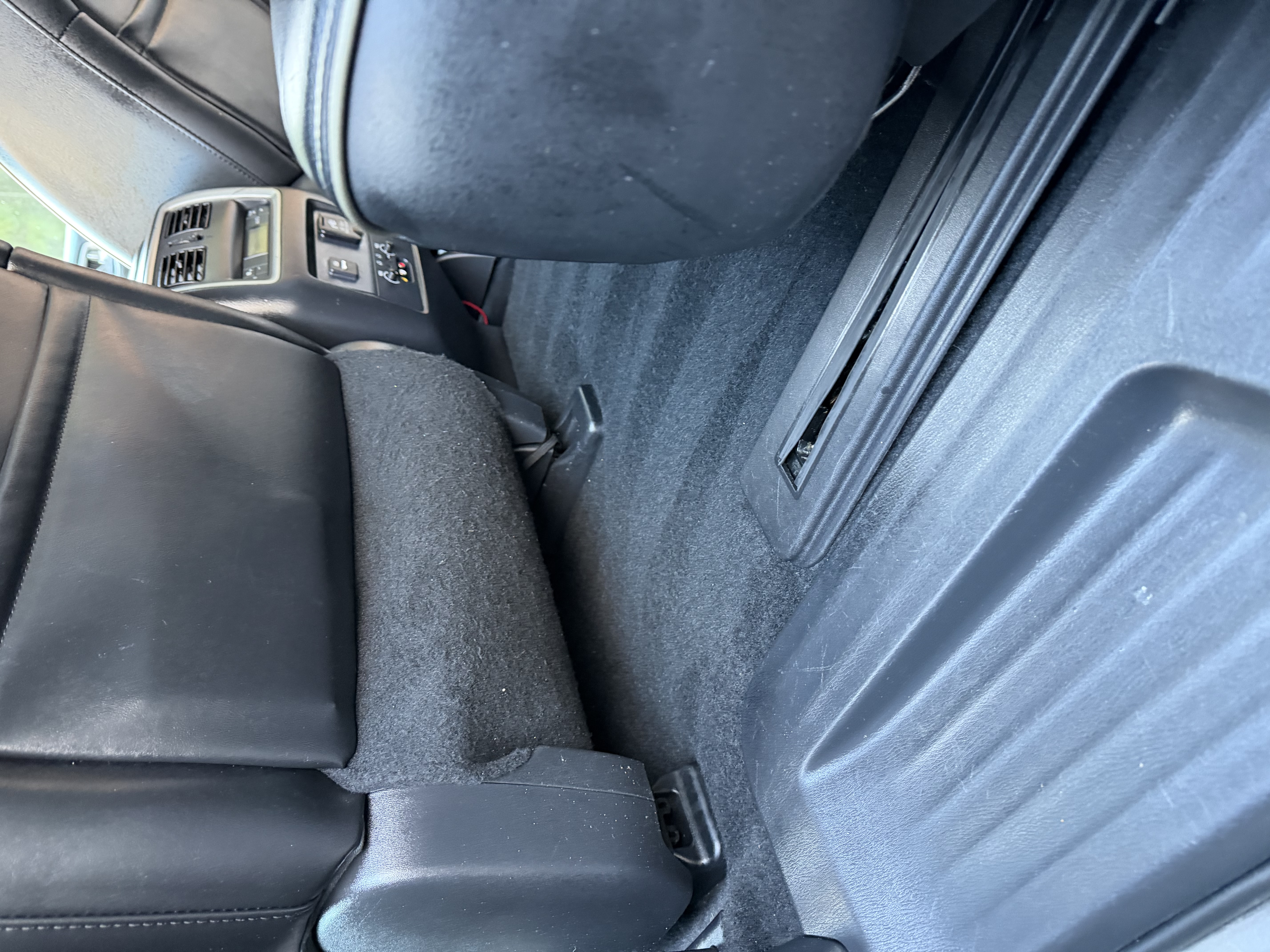 Infiniti rear carpet — food debris before detail